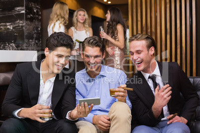 Handsome friends having a drink together