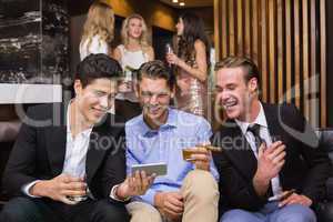 Handsome friends having a drink together