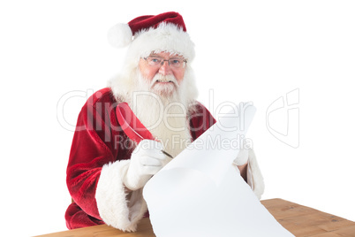 Santa writes something with a feather