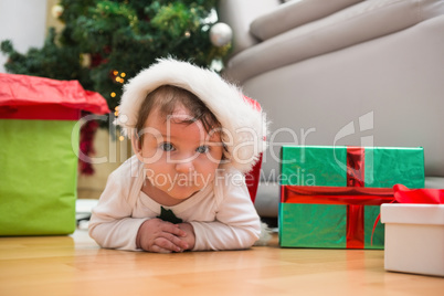 Cute baby boy lying on floor at christmas