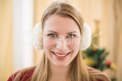 Portrait of a smiling blonde wearing earmuffs