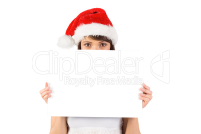 Pretty santa girl smiling at camera with poster