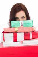 Portrait of a brunette holding pile of gifts