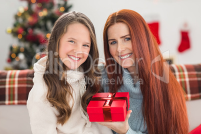 Daughter giving her mother a christmas present