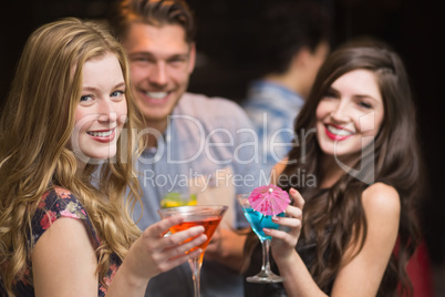 Happy friends having a drink together