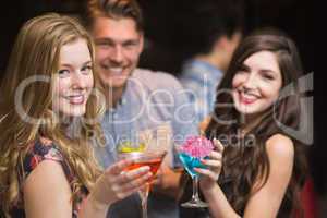 Happy friends having a drink together