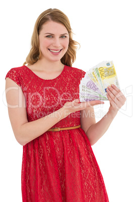 Pretty blonde in red dress showing her cash