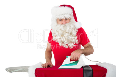 Happy santa claus ironing his jacket