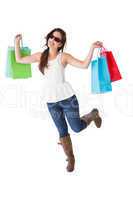 Happy brunette with sunglasses holding shopping bags