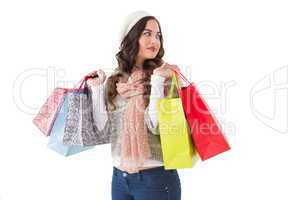 Thoughtful brunette with shopping bags