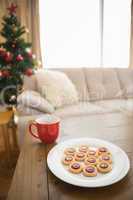 Cookies and mug on coffee table at christmas