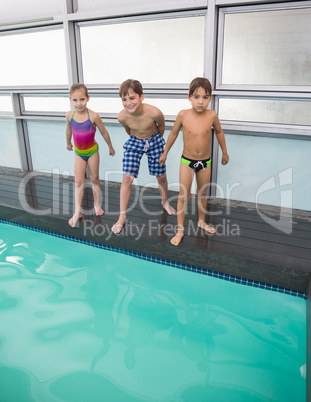 Cute swimming class about to jump in pool