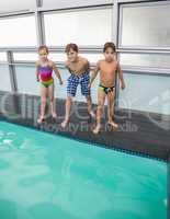 Cute swimming class about to jump in pool