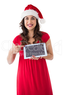 Festive brunette pointing her tablet