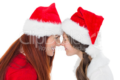 Festive mother and daughter smiling at each other