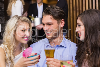 Happy friends having a drink together