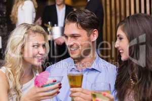 Happy friends having a drink together