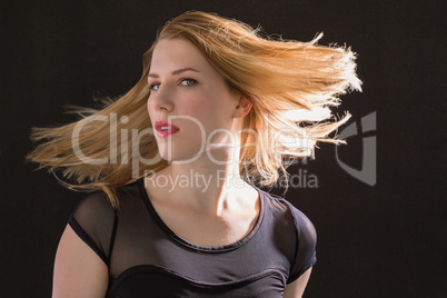 Pretty blonde woman tossing hair