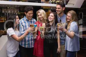 Happy friends having a drink together