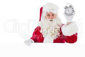 Santa claus holding alarm clock and sign