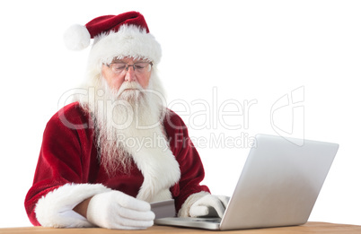 Santa pays with credit card on a laptop