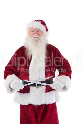Santa Claus measures his belly