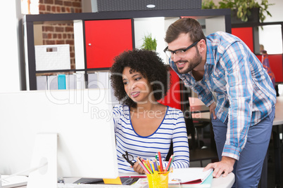 Photo editors using computer in office