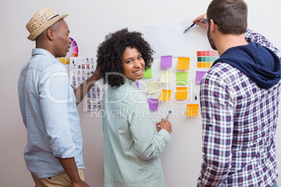 Team looking at sticky notes on wall