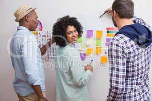 Team looking at sticky notes on wall