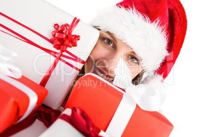 Portrait of a festive young woman holding many gifts