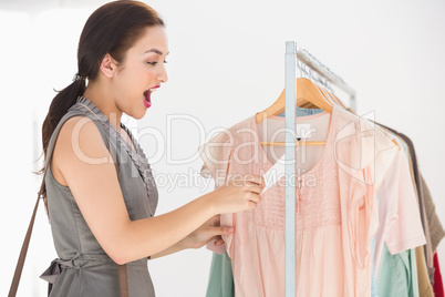 Pretty brunette shocked at price of shirt