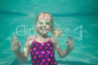 Cute kid posing underwater in pool