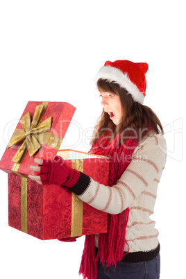 Festive brunette opening a gift