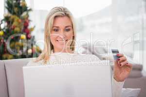 Blonde shopping online on the couch at christmas