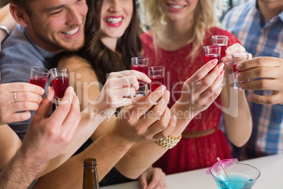 Happy friends having a drink together