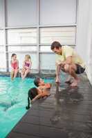 Cute swimming class listening to coach