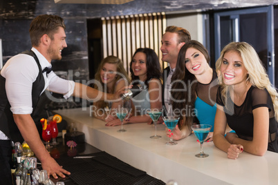 Attractive friends being served cocktails