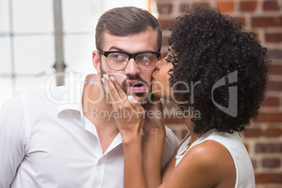 Woman kissing man in office