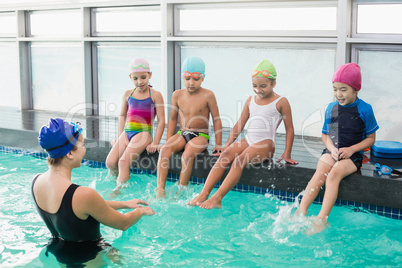 Cute swimming class watching the coach