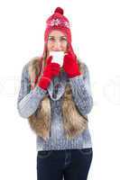 Woman in winter clothes holding a mug