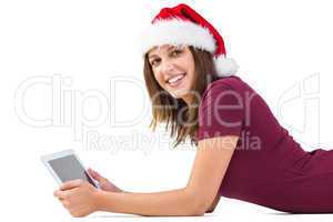 Festive brunette using tablet pc