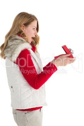 Surprised blonde woman opening gift