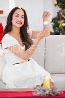 Cheerful brunette holding a bauble at christmas
