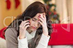 Concentrated brunette on the phone on christmas day