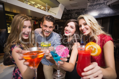 Happy friends having a drink together