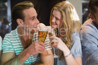 Happy friends having a drink together