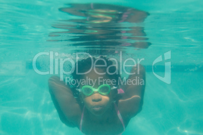 Cute kid posing underwater in pool