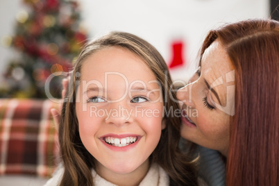 Mother telling her daughter  a christmas secret