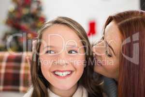 Mother telling her daughter  a christmas secret