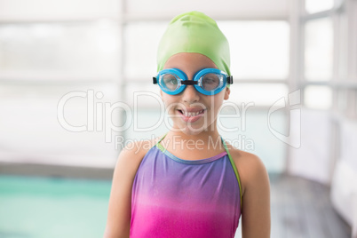 Cute little girl standing poolside